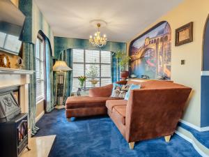 a living room with a couch and a fireplace at The Venetian in Horning