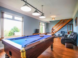 a pool table in a living room with a pool at Cairncroft Cottage in Colfin