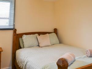 a small bedroom with a bed and a window at Lanburnum Lodge - Uk47076 in Wilberfoss