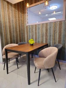 a dining room table and chairs with flowers on it at Centre Apartment in Gyumri