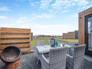 a patio with a table and chairs and a grill at Galloway Ewe - Uk46819 in Wigtown