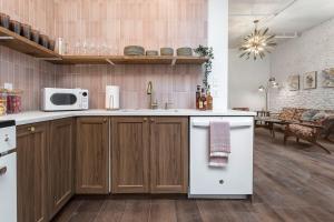 a kitchen with wooden cabinets and a white refrigerator at Skyline Bourbon Loft by Hollyhock Suites 5 Bedrooms-2 baths With Soaking Tub in Louisville +23 photos