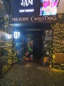 a sign for a merry christmas store with lights at Kapana Stay at Center Plovdiv in Plovdiv