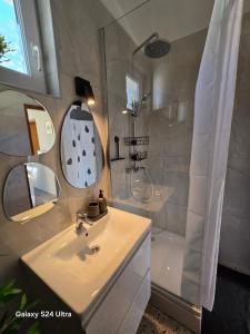 a white bathroom with a sink and a shower at Studio apartment PEGY in Vir