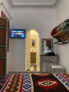 a bedroom with a bed and a mirror on the wall at Zoco Riad in Tangier