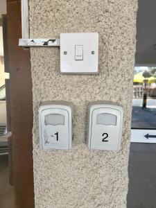 two electrical outlets on a stone wall with numbers on them at Maresea rooms in Larnaca