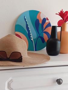 a hat sitting on top of a dresser with a plate at Garden Luz House in Lagos