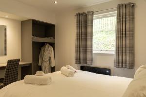 a bedroom with a bed and a window at Marian Resort And Spa in Prestatyn