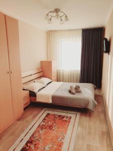 a bedroom with a bed and a window at 2кмн Квартира по проспекту Республики 8 in Astana