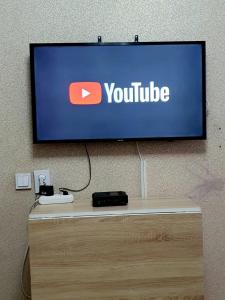 un televisor con una señal de youtube en una pared en 2кмн Квартира по проспекту Республики 8 en Astaná