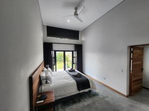 a bedroom with a bed and a ceiling fan at Bald Ibis (856 Highland Gate) in Dullstroom