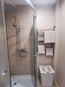 a bathroom with a shower and a toilet and towels at trendy in Ventspils