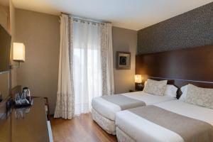 Postel nebo postele na pokoji v ubytování Barcelona Hotel Colonial