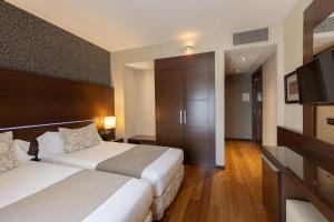 Postel nebo postele na pokoji v ubytování Barcelona Hotel Colonial