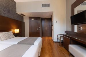 Postel nebo postele na pokoji v ubytování Barcelona Hotel Colonial