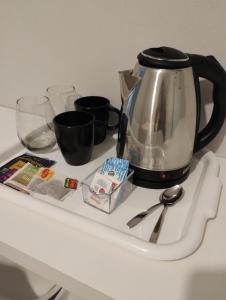 a tea kettle on top of a white counter at Laguna Suites in Miramar