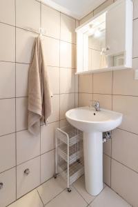 a white bathroom with a sink and a mirror at PROPERSTAY 101 - Casa Leonardo Chalkidiki in Polychrono +37 photos