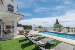 a villa with a swimming pool and a patio at Casa Panoramica in Mijas