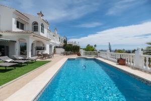 a swimming pool in the backyard of a house at Casa Panoramica in Mijas