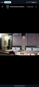 a picture of a room with two beds at Hotel Srimanta sankardev in Majuli