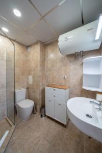 a bathroom with a toilet and a sink at Moana Sunset Apartment in Ahtopol +7 photos