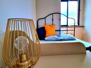 a room with a bed with a cage with a fan at Kopernik Premium Rooms Apartment in Toruń