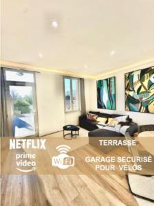 a living room with a couch and a table at Élégance Lauragaise * Wifi * Netflix * Terrasse in Villefranche-de-Lauragais