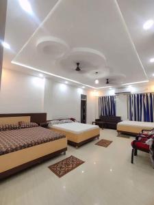 A bed or beds in a room at narayan resort and marriage hall