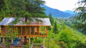 a small house in the middle of a forest at Stargazing Treehouse Himachal in Sainj