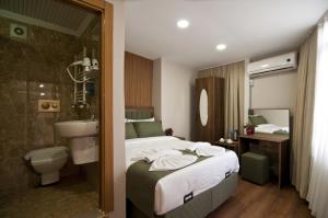 a hotel room with a bed and a bathroom at Aurora Eco Hotel in Istanbul