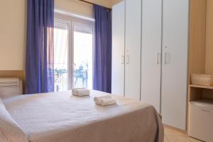 a bedroom with a bed with two towels on it at Affittacamere Piazza Mazzini in Terracina
