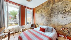 a bedroom with a large map on the wall at Villa Dei 15 pers jacuzzi, baby-foot, 30 min mer in Villedieu-les-Poëles