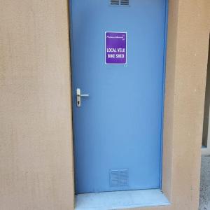 a blue door with a sign on it next to a building at La Calade in L'Isle-sur-la-Sorgue +37 photos
