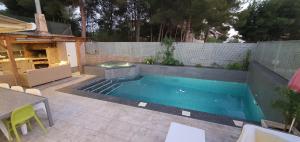 basen w ogrodzie ze stołem i krzesłami w obiekcie Urbanizacion El Pantano villa 4 dormitorios w mieście Alcora