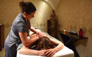 a woman is giving a woman a massage at Ostella Spa & Resort in Bastia +126 photos