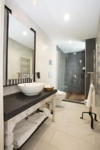 a bathroom with a sink and a toilet at Dedeminn Marina Hotel in Göcek