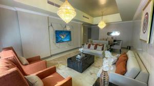 a living room with two couches and a table at HOOUD Apartments in Khor Fakkan