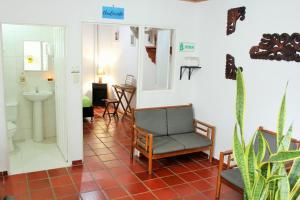 a room with a bathroom with a chair and a sink at Hospedaje Los Capuchinos in Socorro