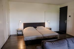 Postel nebo postele na pokoji v ubytování Strand Appartementen Wemeldinge