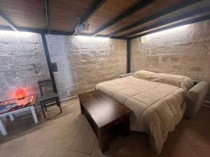 a bedroom with a large bed and a wooden table at La Nuotatrice in Lecce
