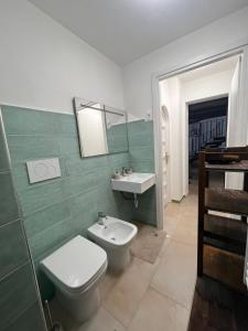 a bathroom with a toilet and a sink at La Nuotatrice in Lecce