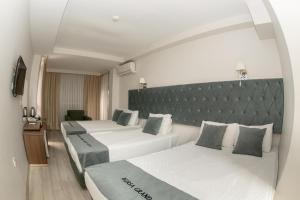 a hotel room with two beds and a large headboard at Bursa Grand Family HOTEL in Bursa +89 photos