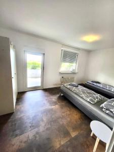 a bedroom with a large bed and a window at nJoy! Comfort & Spacious - Balkon - gratis WLAN - perfekt für Work & Travel in Bietigheim-Bissingen