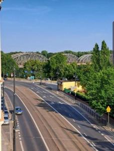 an empty highway with a bridge in the background at Kopernik Premium Rooms Apartment in Toruń