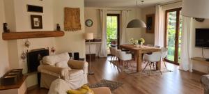 a living room with a fireplace and a table and chairs at Willa Matylda Karpacz in Ściegny +24 photos