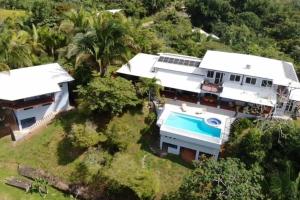 an aerial view of a house with a swimming pool at Luxury Villa with Separate Guest house and 360view in Quepos