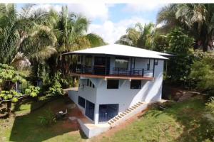 an aerial view of a house with palm trees at Luxury Villa with Separate Guest house and 360view in Quepos