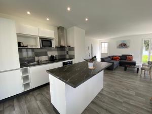 a kitchen with a counter top and a living room at Villa Saint Mart in Saint-Martin-de-Ré