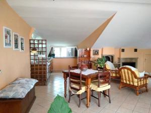 a living room with a table and chairs at la mansarda nel bosco in Tolfa