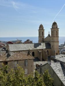 a view of a city with two towers and roofs at Charmant 2 Pièces coeur de Bastia in Bastia